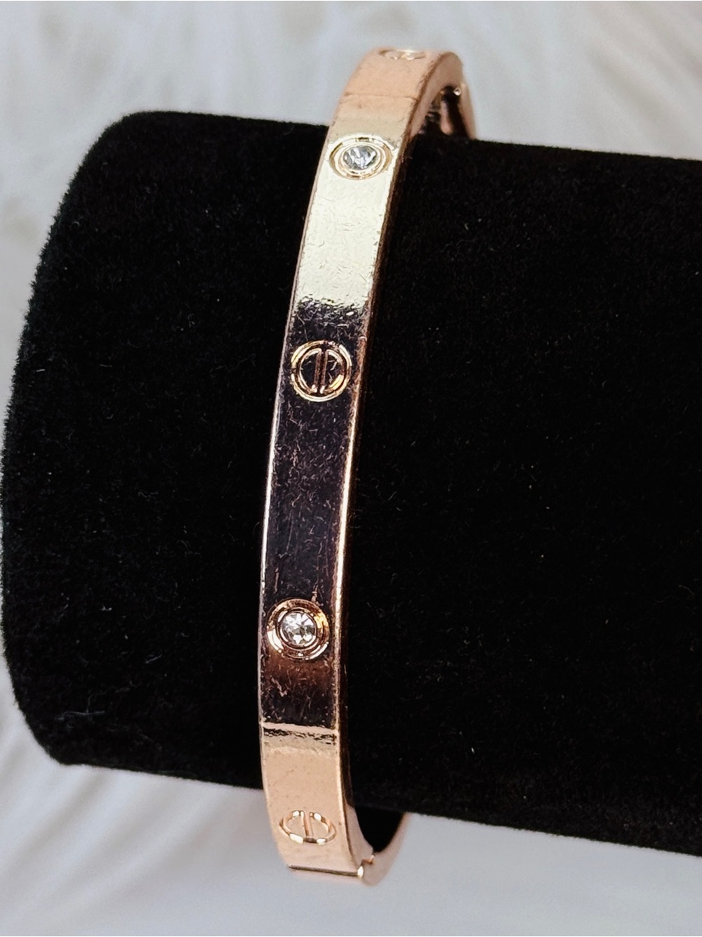 Rose goldtone hinged closure bangle bracelet